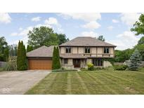 Charming two-story home featuring a well-manicured lawn, stone accents, and a two-car garage at 3818 S Creekside Dr, New Palestine, IN 46163