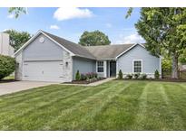 Charming single-story home with blue siding, brick accents, well-manicured lawn and an attached two car garage at 421 E Delaware St, Fortville, IN 46040