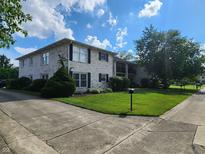 Charming two-story apartment building with white brick and lush green lawn at 4501 N Wheeling Ave # 5E4, Muncie, IN 47304