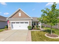 Charming single-story home with a well-manicured lawn and a two-car garage on a beautiful, sunny day at 4905 Lilium Dr, Plainfield, IN 46168