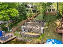 Multi-level backyard with stone patio, and ample seating provides stunning views of the lakefront home at 7082 Muskrat Dr, Nineveh, IN 46164