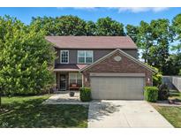 Two-story home featuring a lush front yard and attached two-car garage at 8380 Kolven Dr, Avon, IN 46123