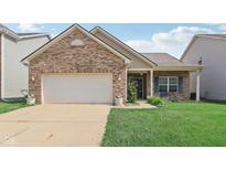 Charming single-story brick home featuring an attached garage and well-maintained front lawn at 958 Denton Ct, Westfield, IN 46074