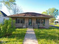 Charming single-story home with a well-maintained lawn and inviting front porch at 1155 E Perry St, Indianapolis, IN 46227