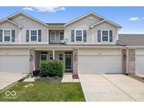 Charming townhouse featuring a well-maintained lawn, 2-car garage, and inviting front entrance at 1158 Thistlewood Way, Plainfield, IN 46168