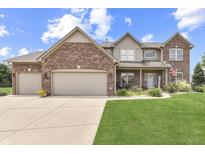 Charming two-story home featuring brick accents, a well-manicured lawn, and an attached two-car garage at 1202 Vestman Ct, Greenwood, IN 46143