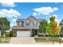 Charming two-story home featuring a brick facade and a well-manicured front yard on a sunny day at 14095 Northcoat Pl, Fishers, IN 46038