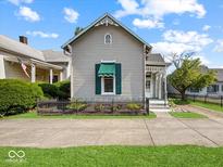 Charming home featuring a decorative front door and well-maintained landscaping at 146 E Broadway St, Shelbyville, IN 46176