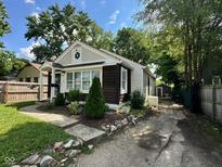Charming home exterior features landscaping, unique windows, and a cozy, inviting entrance at 3711 Hillside Ave, Indianapolis, IN 46218