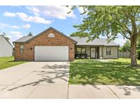 Charming single-story home boasts a brick facade, attached garage, and well-maintained lawn at 6102 Boulder Dr, Anderson, IN 46013