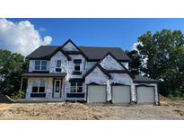 New two-story home featuring a three-car garage, black roof, and bright white windows at 6279 Rippling Rock Dr, Plainfield, IN 46168