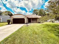 Charming single-story home with a well-maintained lawn and a two-car garage at 7450 Cobblestone W Dr, Indianapolis, IN 46236