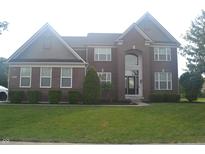 Charming brick two-story home featuring manicured lawn and traditional architectural details at 10166 Ranford Blvd, Fishers, IN 46040