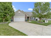 Charming single-story home featuring a two-car garage, manicured lawn, and mature trees in a well-kept neighborhood at 15372 Black Gold Ct, Noblesville, IN 46060