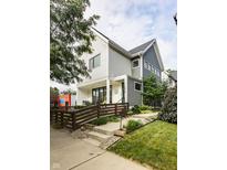 Charming two-story home with a landscaped front yard and inviting front porch swing at 1610 N Alabama St, Indianapolis, IN 46202