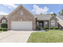 Beautiful brick home with a well-maintained lawn and attached two-car garage at 1645 Oakmere Way, Greenwood, IN 46142