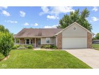 Charming one-story home with a well-manicured lawn and an attached two-car garage at 31 Morningside Ct, Whiteland, IN 46184