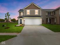 Inviting two-story home featuring a pristine lawn, neutral siding, and a spacious two-car garage at 3142 Lennon Ln, Indianapolis, IN 46235