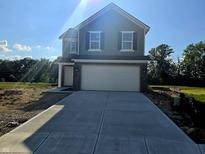 Charming two-story home with a brick-accented garage and a concrete driveway, perfect for modern living at 3142 Lennon Ln, Indianapolis, IN 46235