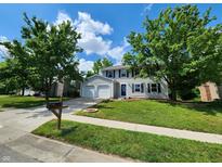 Charming two-story home featuring a well-maintained lawn, attached garage, and inviting curb appeal at 4536 Clayburn Dr, Indianapolis, IN 46268