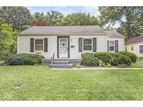 Charming home with a well-maintained front yard, dark shutters, and a covered porch at 5315 Rosslyn Ave, Indianapolis, IN 46220