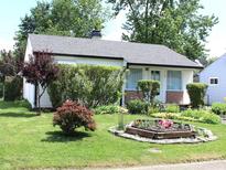Charming single-story home with well-maintained landscaping and flower beds at 5409 E 19Th St, Indianapolis, IN 46218