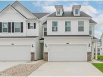 Charming townhome featuring a two-car garage, dormer windows and modern farmhouse architectural details at 7282 Shroyer Way, Noblesville, IN 46062