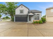 Charming two-story home with a dark garage door, neutral siding and well-manicured landscaping at 772 Cembra Dr, Greenwood, IN 46143