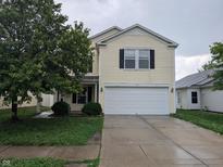 Traditional two-story home with a two-car garage and neutral color palette at 908 Belvedere Dr, Shelbyville, IN 46176
