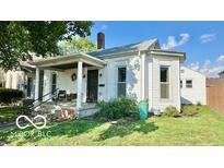 Charming home with a covered porch and well-maintained front yard at 909 Pearl St, Columbus, IN 47201