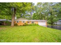 Charming brick ranch-style home with attached garage and mature trees at 10104 Sycamore Ln, Indianapolis, IN 46239