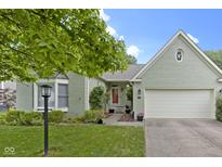 Charming one-story home with a brick facade, attached garage, and beautifully landscaped front yard at 1114 Clairborne Ct, Indianapolis, IN 46280