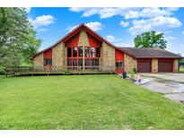 Charming home featuring stone accents, a two-car garage, and a spacious front yard at 13151 W Youth Camp Rd, Columbus, IN 47201