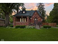 Charming brick home with a well-manicured lawn and inviting front porch at 1420 E Loretta Dr, Indianapolis, IN 46227