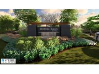 An entrance to a neighborhood with a stone sign and landscaped garden at 14565 Bedford Falls Dr, Carmel, IN 46032