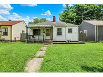 Charming single story home with a covered porch and a well maintained lawn at 2029 N Colorado Ave, Indianapolis, IN 46218