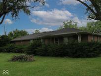 Single-story brick home with well-maintained landscaping and a beautiful yard at 3103 Westenedge Dr, Columbus, IN 47203