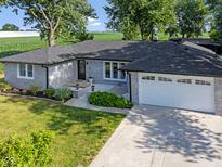 Charming ranch home featuring a brick exterior, well-manicured lawn, and an attached two-car garage at 3777 W State Road 234, McCordsville, IN 46055