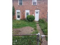 Home exterior with brick facade and overgrown front yard needing some love at 8256 Meadowlark Dr, Indianapolis, IN 46226