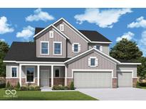 Charming two-story home with stone accents, a three-car garage and manicured lawn at 19796 Chatham Shore Ln, Westfield, IN 46074