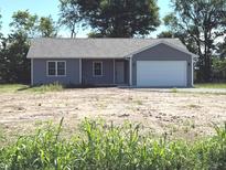 Charming single-story home featuring gray siding, a two-car garage, and a well-manicured lawn at 2071 S Friendship Dr, Paragon, IN 46166