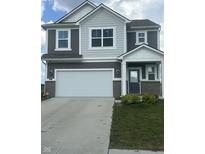 Charming two-story home features a gray and white exterior, attached two-car garage, and welcoming entrance at 269 Switchgrass Ln, New Whiteland, IN 46184