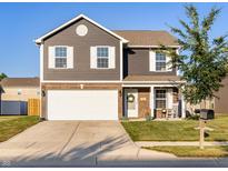 Charming two-story home with a well-maintained lawn and inviting curb appeal at 341 Thistlewood Dr, Greenfield, IN 46140