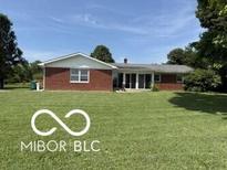 Charming brick ranch home with well-maintained lawn and mature trees on a sunny day at 4680 Cartersburg Rd, Plainfield, IN 46168