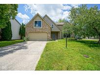 Charming brick two-story home with well-maintained lawn and attached two car garage at 5640 Dapple Ct, Indianapolis, IN 46228