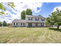 Inviting two-story home featuring a well-manicured lawn, classic shutters and a welcoming facade at 12602 Lockerbie Cir, Carmel, IN 46033