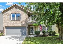 Charming two-story home featuring a well-maintained lawn and a gray two-car garage at 14373 Orange Blossom Trl, Fishers, IN 46038
