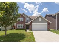 Charming two-story home with brick and vinyl siding, complemented by a well-maintained front yard and two-car garage at 2458 Bristol Dr, Franklin, IN 46131