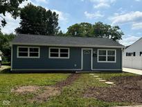 Charming home with gray siding, white trim, new roof, and a well-manicured lawn at 2907 Baltimore Ave, Indianapolis, IN 46218