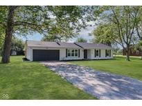 Charming single-story home with a well-manicured lawn and a long driveway at 3120 S Meridian Rd, Greenfield, IN 46140